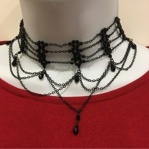 Surrounding the neck is this delicate black beaded necklace